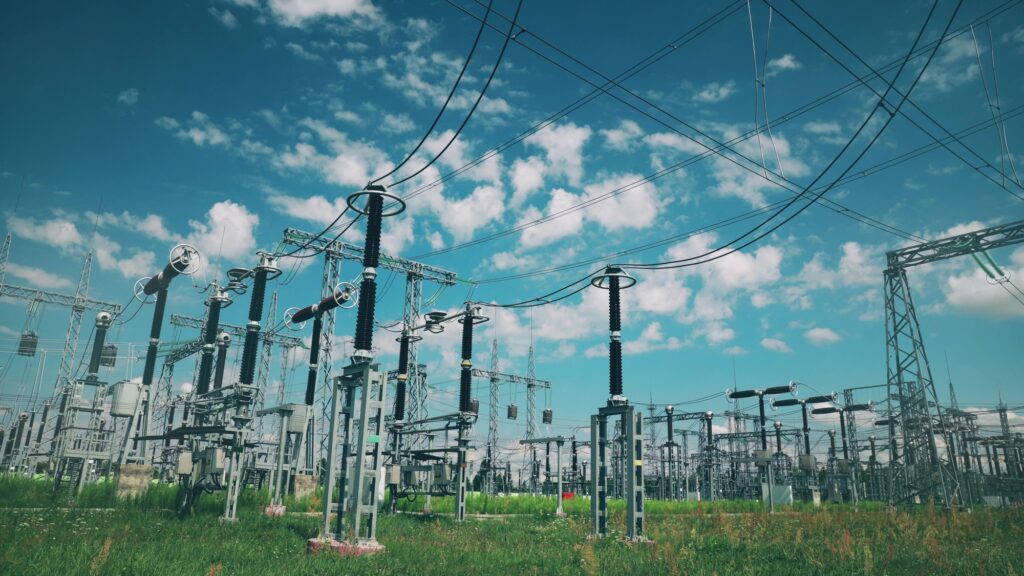 Power Grid Station. Electrical Distribution Station, Transformers, High-voltage Lines In Sunny